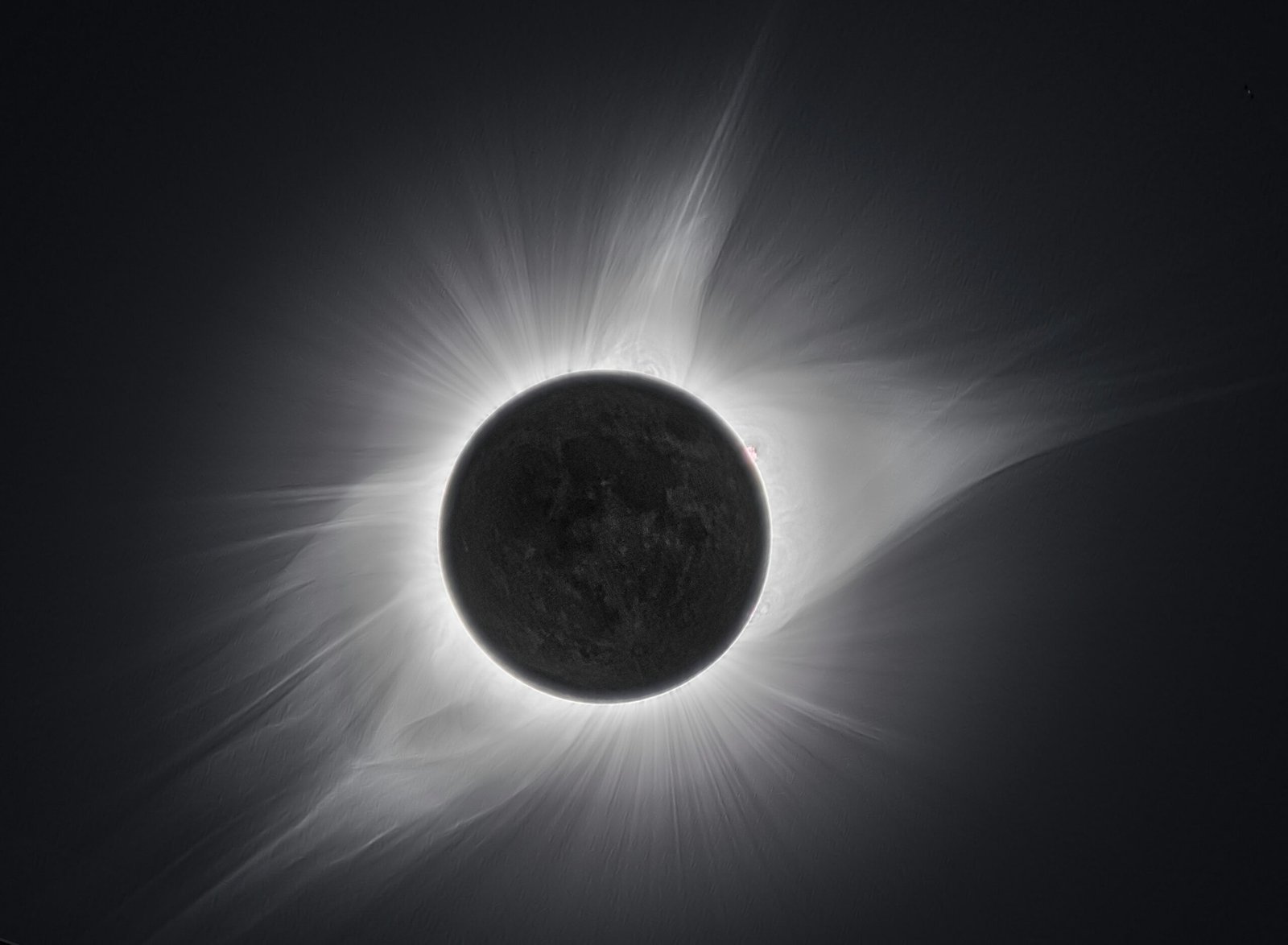 a solar eclipse is seen in the dark sky